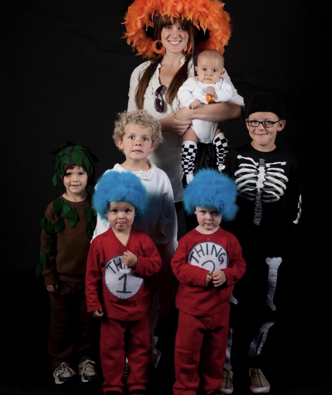 Our family on Halloween 2011: Owen as a tree in brown sweats and felt leaves, with his brothers in costume and me holding the baby