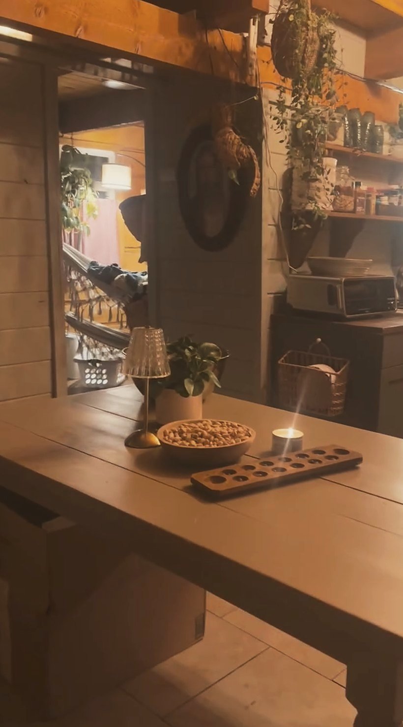 A lamplit table in the tiny cabin