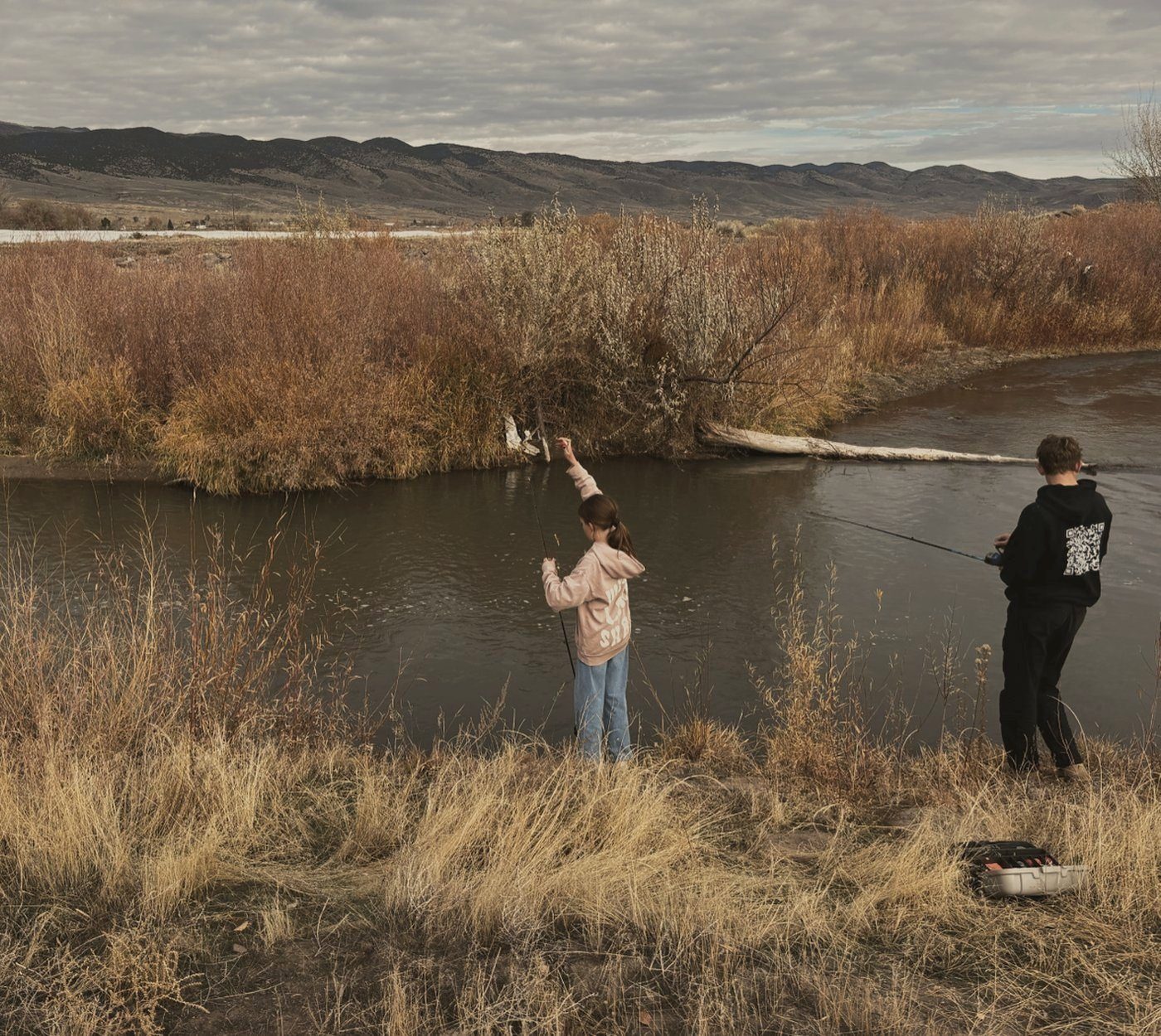 Fishing the river under golden autumn willows
