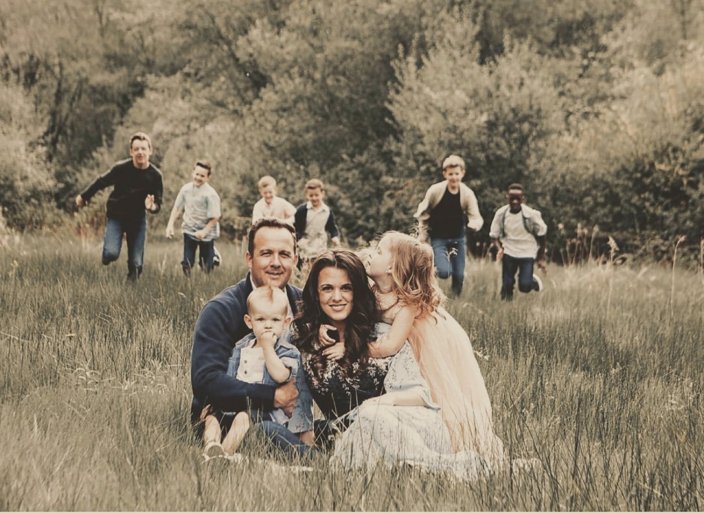 Our family in tall grass, the kids running toward us